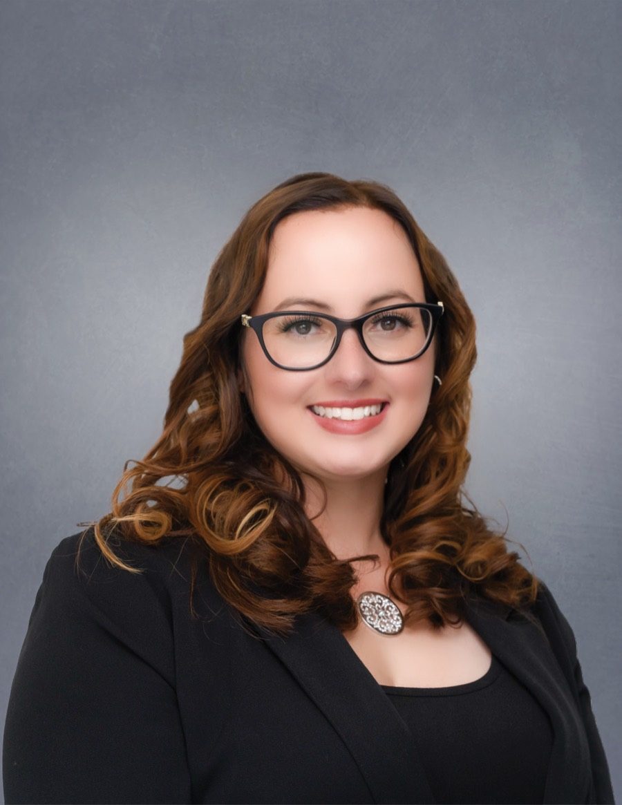 Brittany Sheehan, REALTOR®, smiling in a black blazer